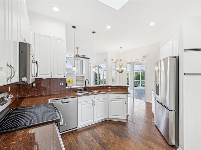 13922 Talmage Loop, Hudson, FL 34667 - kitchen with stainless steel appliances, a sink, dark wood-style flooring, white cabinetry, and recessed lighting
