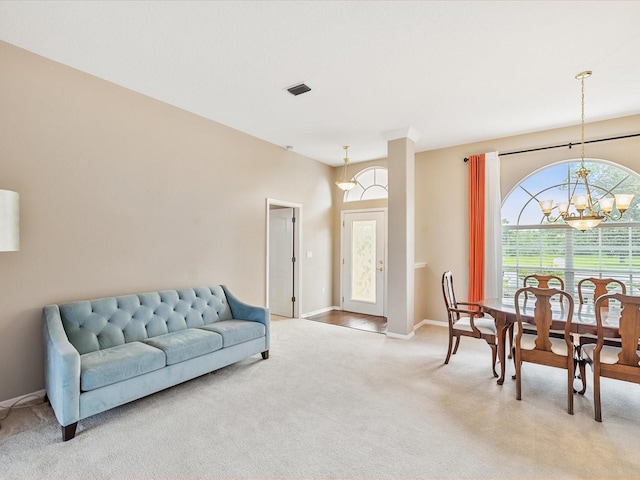 13922 Talmage Loop, Hudson, FL 34667 - living area with a chandelier, light colored carpet, and baseboards