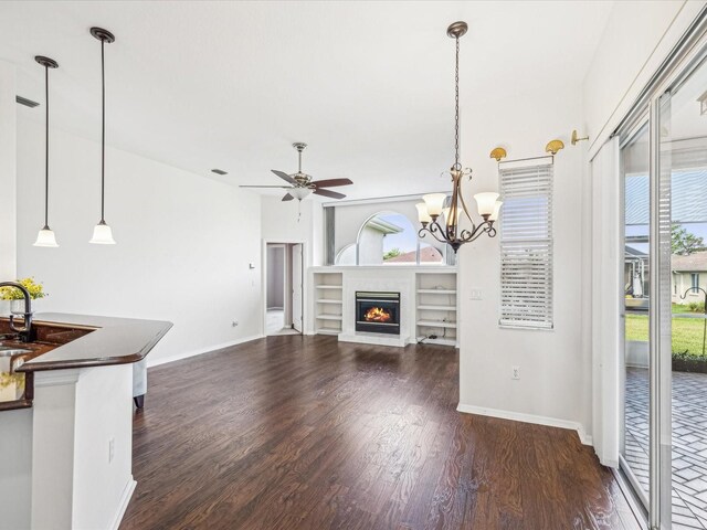 13922 Talmage Loop, Hudson, FL 34667 - unfurnished living room featuring wood finished floors, baseboards, and a ceiling fan