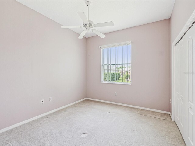 13922 Talmage Loop, Hudson, FL 34667 - unfurnished bedroom with carpet flooring, a closet, baseboards, and a ceiling fan