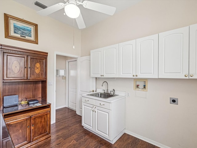 13922 Talmage Loop, Hudson, FL 34667 - washroom with hookup for an electric dryer, washer hookup, dark wood-style flooring, a ceiling fan, and baseboards