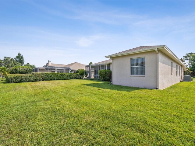 13922 Talmage Loop, Hudson, FL 34667 - view of green lawn featuring central air condition unit and a sunroom
