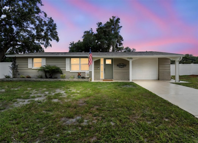 7545 Banner St, New Port Richey, FL 34653 - ranch-style home with a garage, driveway, and brick siding