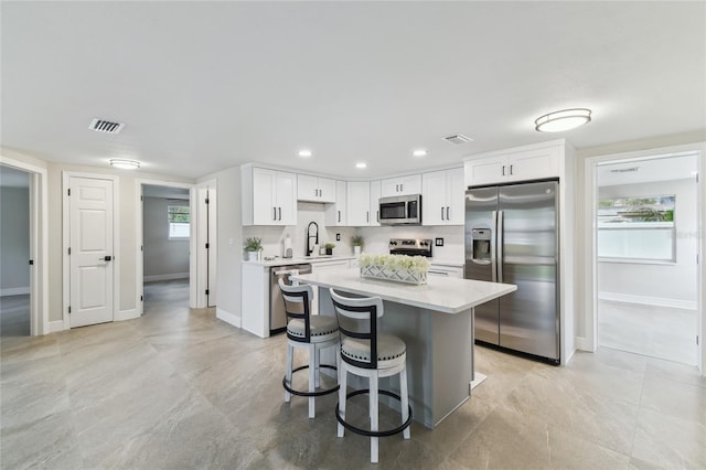 7545 Banner St, New Port Richey, FL 34653 - kitchen with appliances with stainless steel finishes, light countertops, white cabinets, baseboards, and recessed lighting