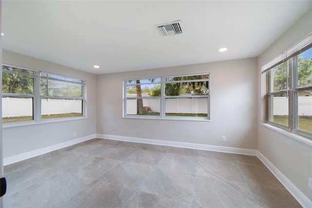 7545 Banner St, New Port Richey, FL 34653 - empty room with baseboards, recessed lighting, and stone finish flooring