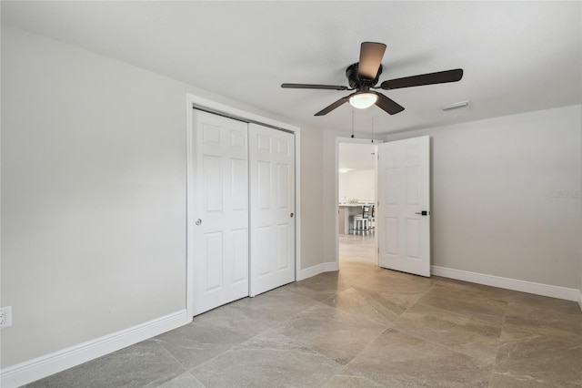 7545 Banner St, New Port Richey, FL 34653 - unfurnished bedroom with a closet, baseboards, and a ceiling fan