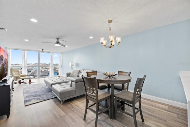 4939 Floramar Ter Unit 611, New Port Richey, FL 34652 - dining area with light wood-style floors, a chandelier, baseboards, recessed lighting, and a textured ceiling