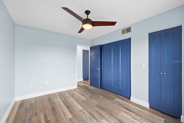 4939 Floramar Ter Unit 611, New Port Richey, FL 34652 - unfurnished bedroom featuring light wood-type flooring, baseboards, and ceiling fan