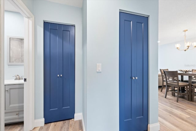 4939 Floramar Ter Unit 611, New Port Richey, FL 34652 - entrance foyer with light wood-type flooring, a chandelier, and baseboards