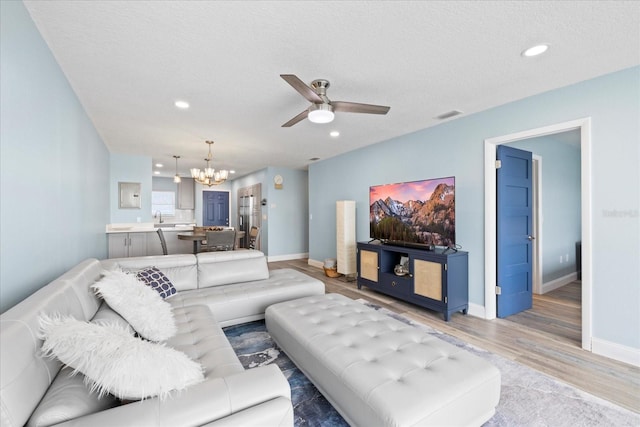 4939 Floramar Ter Unit 611, New Port Richey, FL 34652 - living area with a chandelier, ceiling fan, light wood-type flooring, baseboards, and recessed lighting