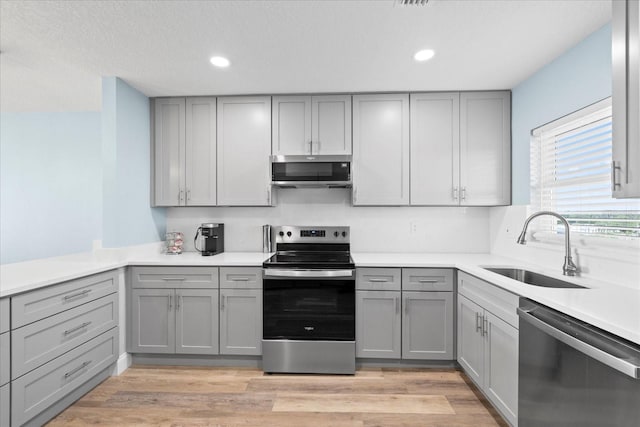 4939 Floramar Ter Unit 611, New Port Richey, FL 34652 - kitchen featuring stainless steel appliances, gray cabinets, a sink, recessed lighting, and light countertops