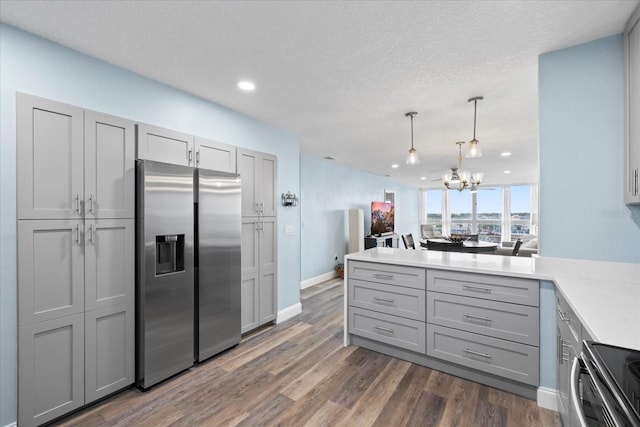 4939 Floramar Ter Unit 611, New Port Richey, FL 34652 - kitchen with stainless steel refrigerator with ice dispenser, gray cabinets, a peninsula, dark wood-style floors, and recessed lighting