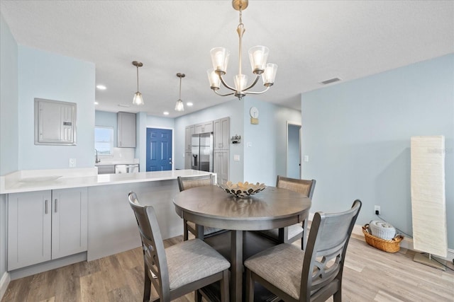 4939 Floramar Ter Unit 611, New Port Richey, FL 34652 - dining area with light wood finished floors, a chandelier, electric panel, and recessed lighting