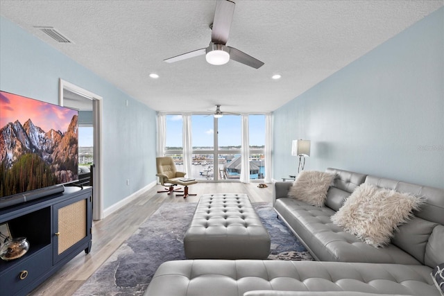 4939 Floramar Ter Unit 611, New Port Richey, FL 34652 - living room featuring ceiling fan, wood finished floors, a textured ceiling, recessed lighting, and baseboards