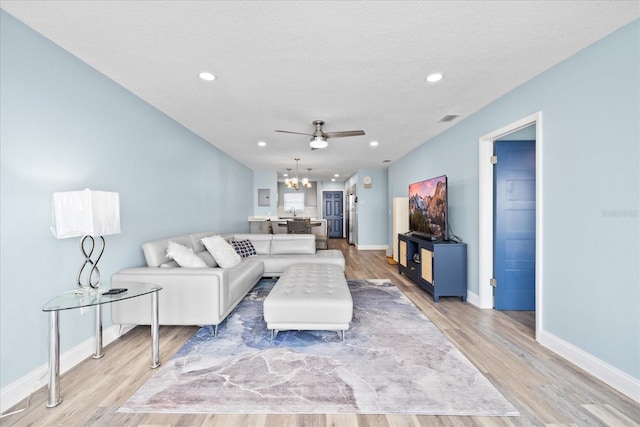 4939 Floramar Ter Unit 611, New Port Richey, FL 34652 - living room featuring a chandelier, light wood-style floors, ceiling fan, baseboards, and recessed lighting