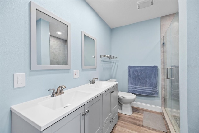 4939 Floramar Ter Unit 611, New Port Richey, FL 34652 - full bath with double vanity, a stall shower, wood finished floors, and toilet