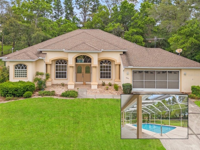 12805 Coronado Dr, Spring Hill, FL 34609 - view of front of home with stucco siding, a front yard, a shingled roof, and a garage