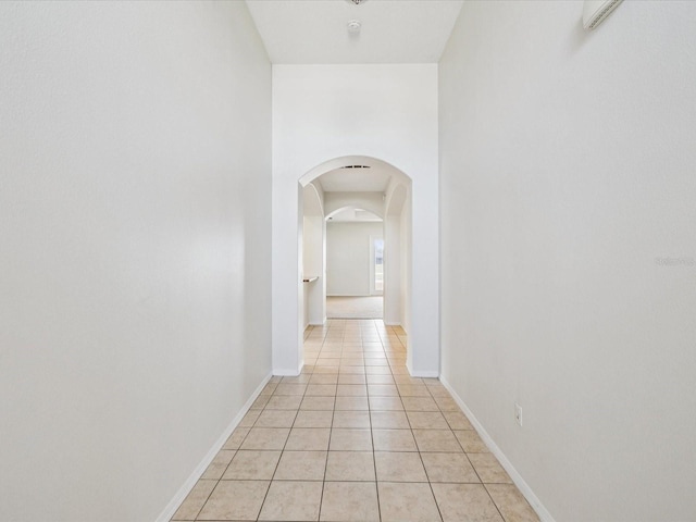 4266 High Ridge Ave, Spring Hill, FL 34609 - corridor with arched walkways, light tile patterned floors, and baseboards