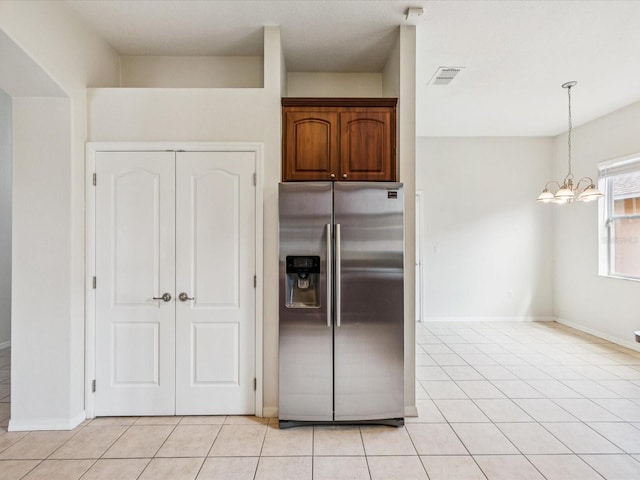 4266 High Ridge Ave, Spring Hill, FL 34609 - kitchen with stainless steel fridge with ice dispenser, light tile patterned floors, a chandelier, and baseboards