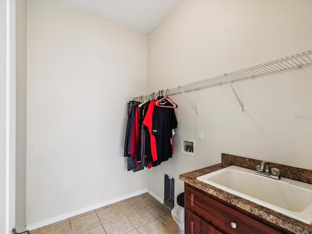 4266 High Ridge Ave, Spring Hill, FL 34609 - laundry room with hookup for a washing machine, baseboards, and light tile patterned flooring