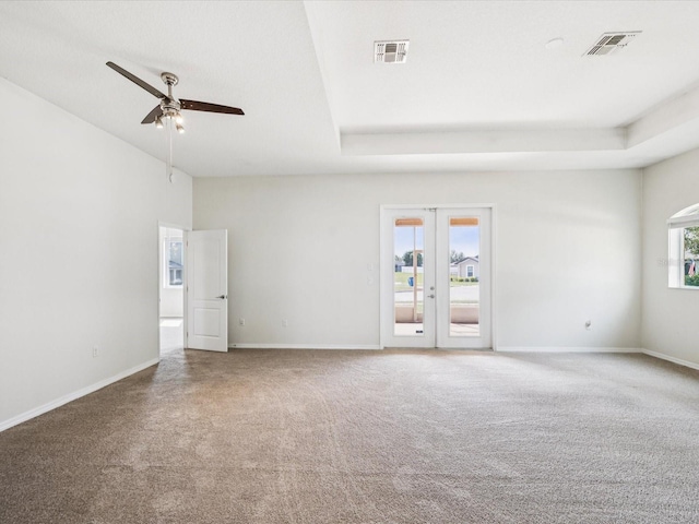 4266 High Ridge Ave, Spring Hill, FL 34609 - carpeted empty room featuring ceiling fan, baseboards, french doors, and a tray ceiling