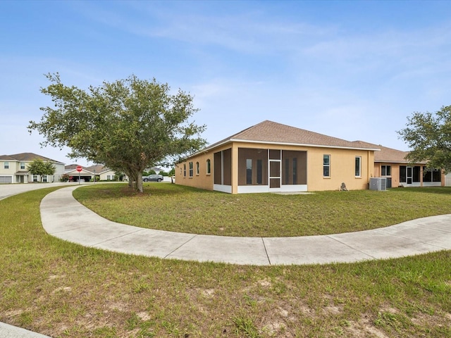 4266 High Ridge Ave, Spring Hill, FL 34609 - rear view of house featuring a yard, a sunroom, and stucco siding
