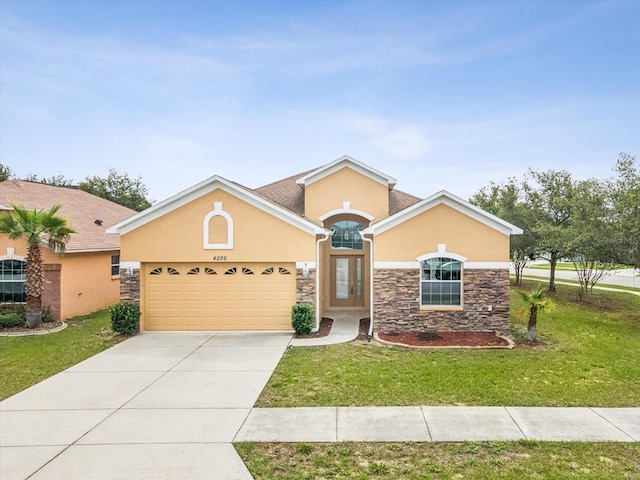 4266 High Ridge Ave, Spring Hill, FL 34609 - view of front facade with stone siding, stucco siding, a front yard, an attached garage, and driveway