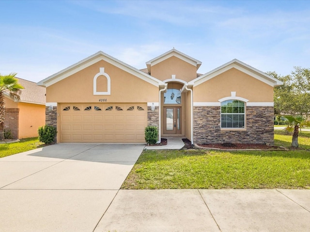 4266 High Ridge Ave, Spring Hill, FL 34609 - view of front facade featuring stone siding, stucco siding, an attached garage, a front yard, and driveway