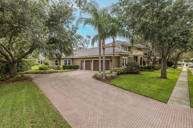 10531 Pontofino Cir, Trinity, FL 34655 - view of front of property featuring decorative driveway, a garage, a tiled roof, stucco siding, and a front yard