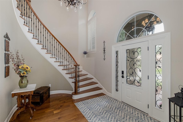 10531 Pontofino Cir, Trinity, FL 34655 - foyer entrance with a chandelier, stairway, wood finished floors, a towering ceiling, and baseboards