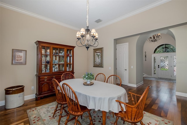 10531 Pontofino Cir, Trinity, FL 34655 - dining room featuring arched walkways, a chandelier, dark wood-style floors, ornamental molding, and baseboards