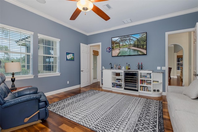 10531 Pontofino Cir, Trinity, FL 34655 - living room with wine cooler, arched walkways, a ceiling fan, plenty of natural light, and ornamental molding