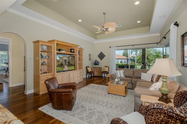 10531 Pontofino Cir, Trinity, FL 34655 - living area featuring a raised ceiling, wood finished floors, healthy amount of natural light, ceiling fan, and crown molding