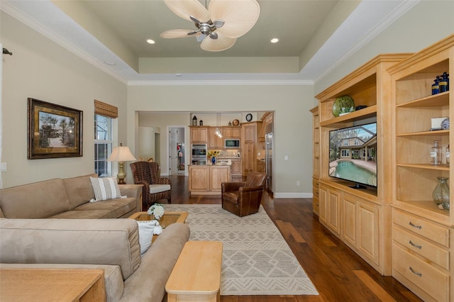 10531 Pontofino Cir, Trinity, FL 34655 - living area featuring ceiling fan, a raised ceiling, dark wood-type flooring, baseboards, and ornamental molding