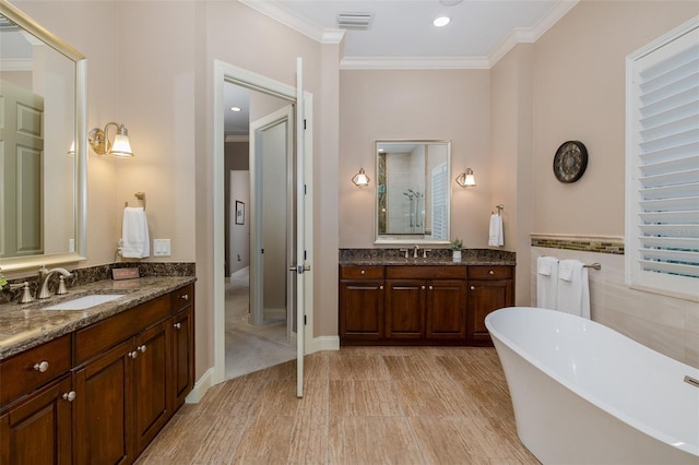 10531 Pontofino Cir, Trinity, FL 34655 - full bathroom with a freestanding bath, two vanities, ornamental molding, and recessed lighting
