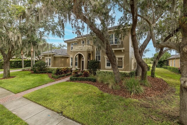 10531 Pontofino Cir, Trinity, FL 34655 - mediterranean / spanish home with a balcony, stucco siding, and a front lawn
