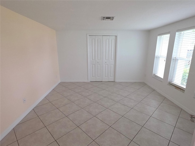 7313 Hatteras Dr, Hudson, FL 34667 - unfurnished room featuring light tile patterned flooring and baseboards