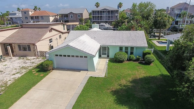 7313 Hatteras Dr, Hudson, FL 34667 - view of front facade with a residential view, a tile roof, a garage, stucco siding, and driveway