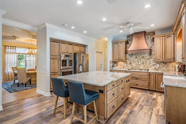 2880 Chelsea Pl N, Clearwater, FL 33759 - kitchen featuring stainless steel appliances, custom range hood, light stone counters, a chandelier, and a breakfast bar