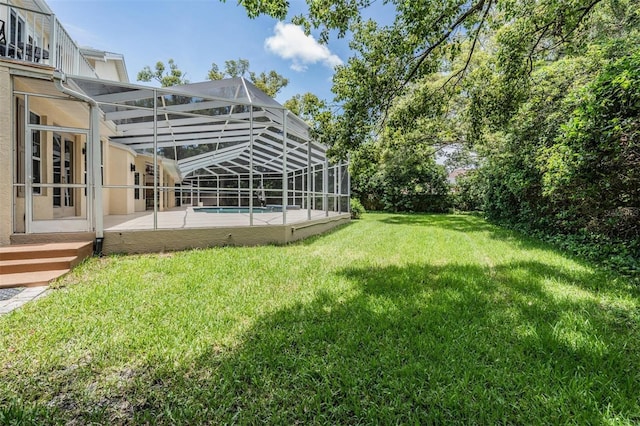 2880 Chelsea Pl N, Clearwater, FL 33759 - view of green lawn with an outdoor pool, a patio area, and a lanai