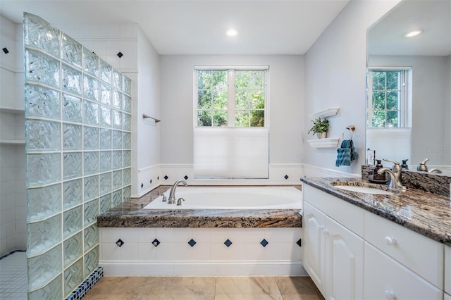 2880 Chelsea Pl N, Clearwater, FL 33759 - bathroom featuring a garden tub, vanity, a walk in shower, and recessed lighting