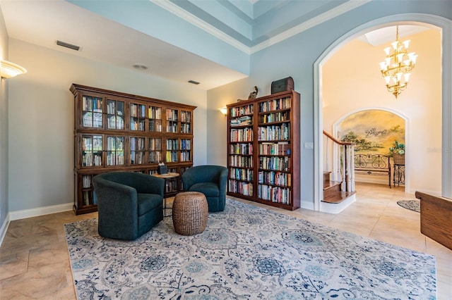 2880 Chelsea Pl N, Clearwater, FL 33759 - sitting room featuring arched walkways, a chandelier, stairs, and crown molding