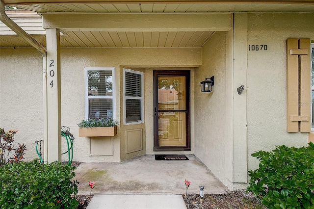 10670 43rd St N Unit 204, Clearwater, FL 33762 - entrance to property featuring stucco siding and a porch