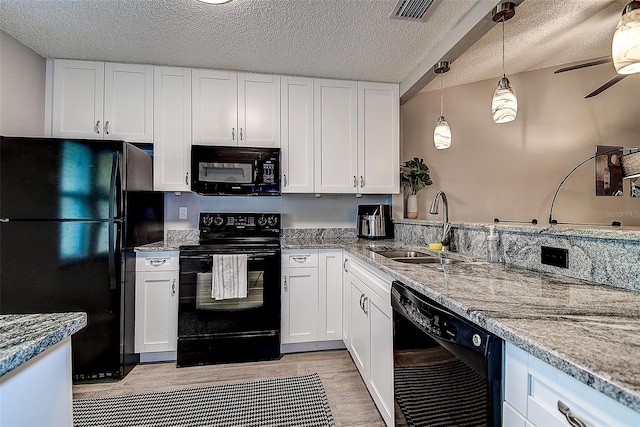10670 43rd St N Unit 204, Clearwater, FL 33762 - kitchen featuring black appliances, a sink, white cabinets, a textured ceiling, and ceiling fan