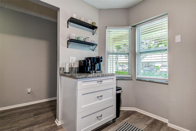 10670 43rd St N Unit 204, Clearwater, FL 33762 - bar with dark wood-type flooring and baseboards
