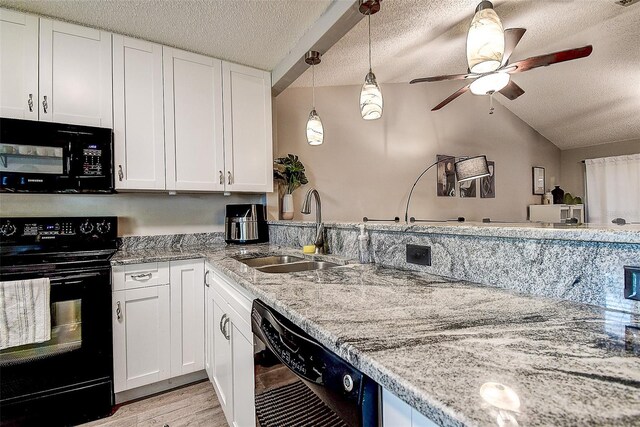 10670 43rd St N Unit 204, Clearwater, FL 33762 - kitchen featuring black appliances, a sink, a textured ceiling, white cabinets, and light stone counters