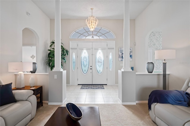 10250 Locker Dr, Spring Hill, FL 34608 - foyer with ornate columns, carpet floors, a chandelier, and baseboards