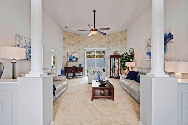 10250 Locker Dr, Spring Hill, FL 34608 - carpeted living room with ornate columns, ceiling fan, and a towering ceiling