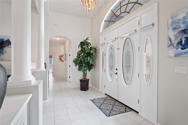 10250 Locker Dr, Spring Hill, FL 34608 - entrance foyer with decorative columns, light tile patterned flooring, and arched walkways