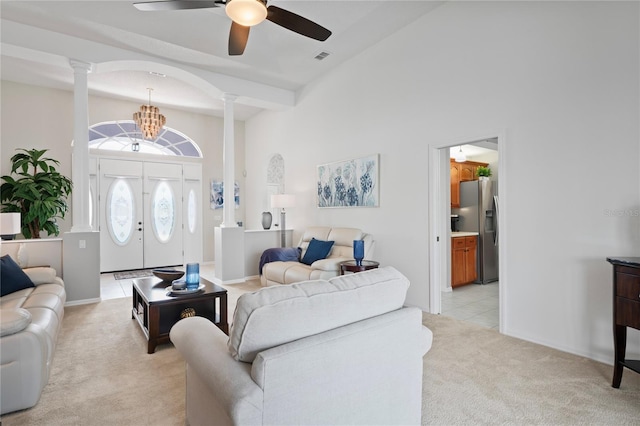 10250 Locker Dr, Spring Hill, FL 34608 - living room with ornate columns, light colored carpet, ceiling fan, and a high ceiling